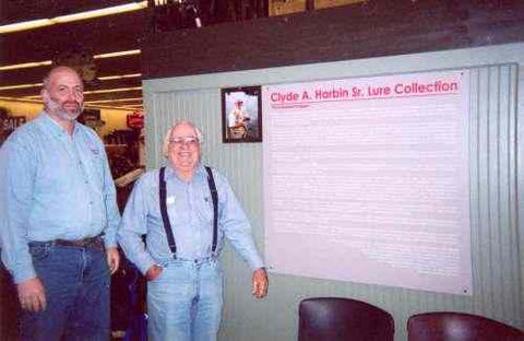 Clyde A. Harbin and Rick Collins by the essay board of the Clyde A. Harbin Sr. Lure Collection story.  Bass Pro Shops featured this story at the Sportsman's Warehouse Store in Memphis.
