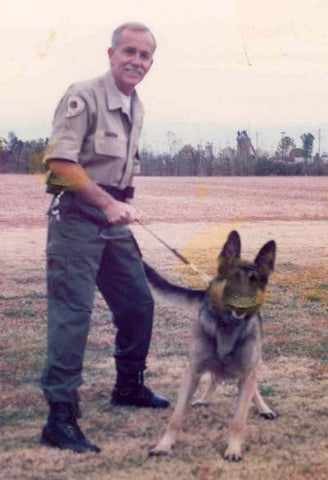 Deputy Sheriff C. A. Harbin II poses with his trained narcotics detector dog.  Narcotics dog "Bruno" finished 20th out of 136 teams entered in the 1996 National Narcotics Trials.  Clyde and Bruno are now both retired.