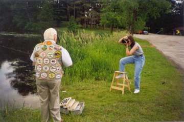 Ms. Kris Kandler (Corporate Photographer) is photographing the action at the Iola Pond while Mr. Harbin demonstrates casting and retrieving the red and white Heddon, River Runt Spook lure.
