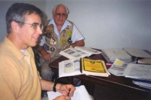 Paul Kennedy and Clyde Harbin with a copy of James Heddon Sons Book