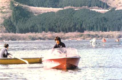 Mr. Masamichi Yamada is motoring the red boat on Lake Ashunoko.    There were many fishermen fishing that day on Lake Ashunoko.