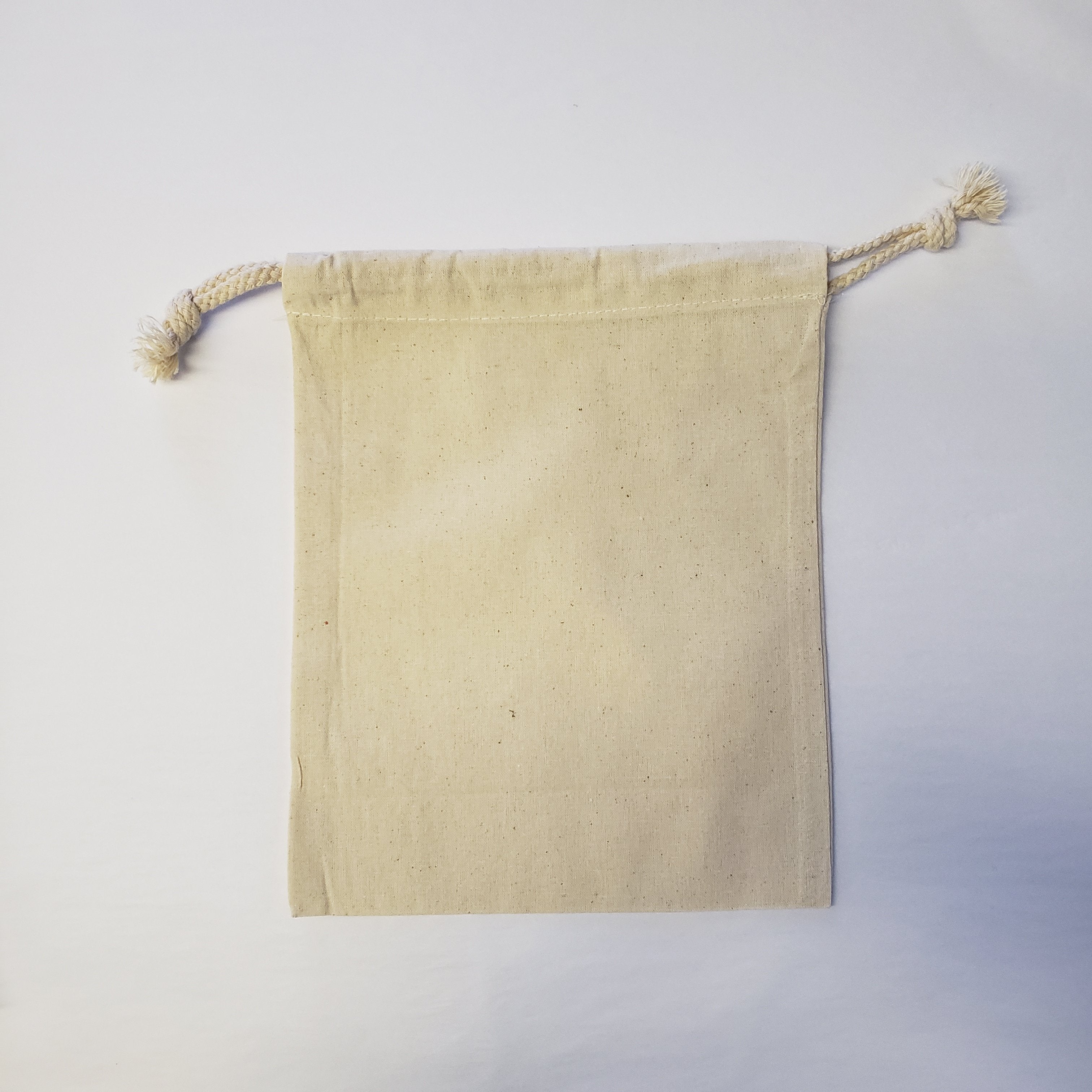 Extra Small Natural Cotton Drawstring Bags from stock in packs 10 available  next working day.