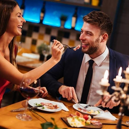 A couple enjoying a romantic dinner and having fun