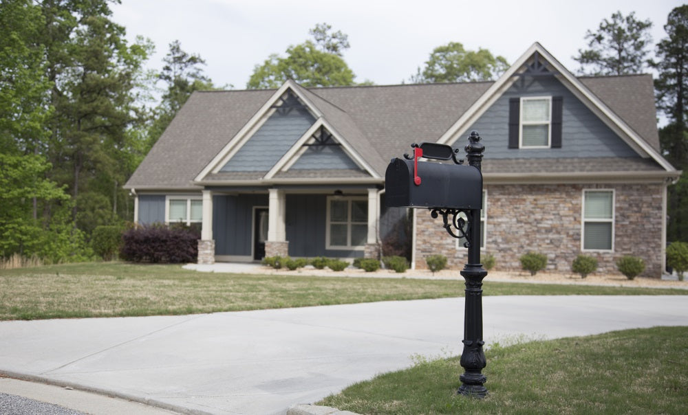 All-black mailbox and post in front of a house