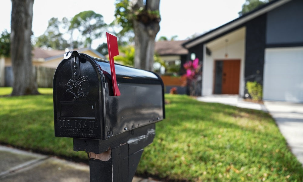 Black mailbox in front of a house