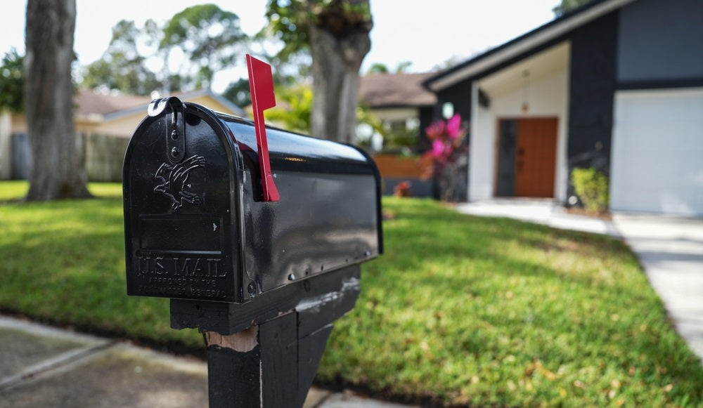 Black mailbox in front of a house