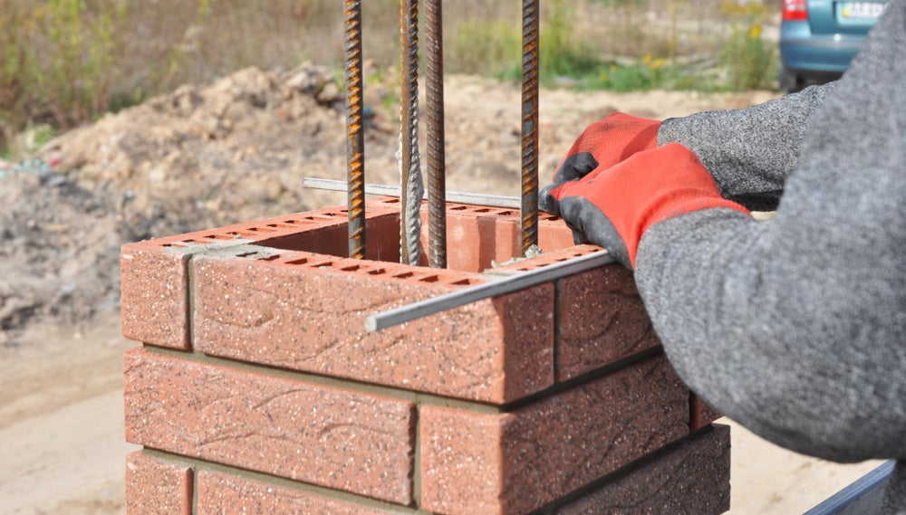 Closeup on brick laying blocks correctly on fence brick column