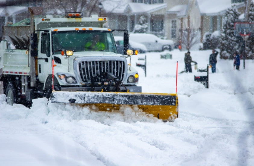 Snowplow truck clearing the road after heavy snowfall