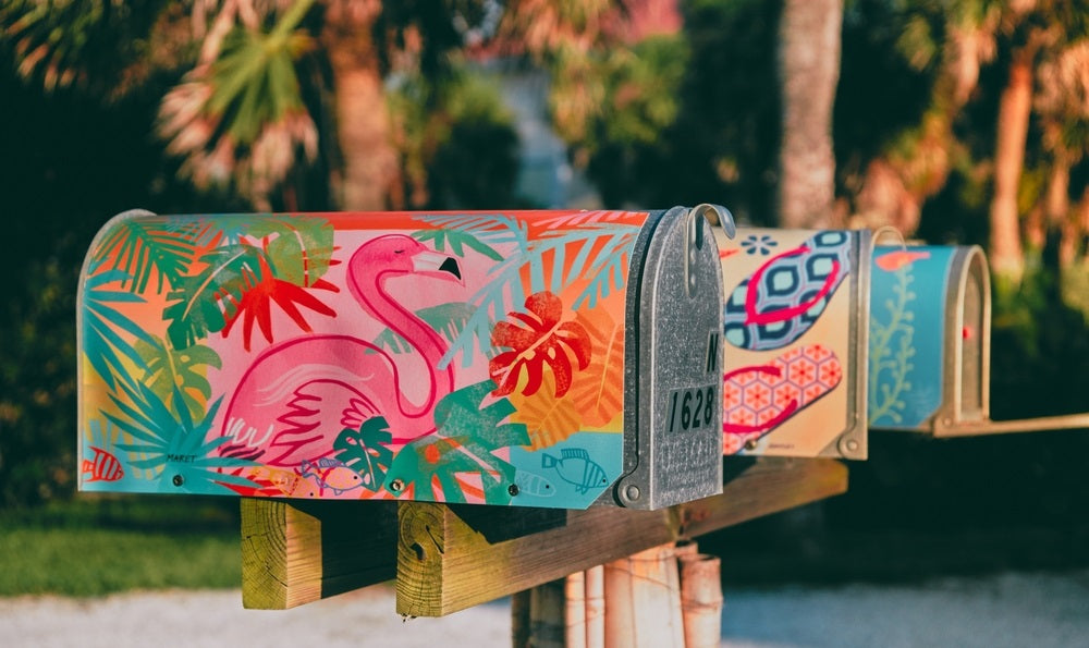 a colorful mailbox with pink flamenco