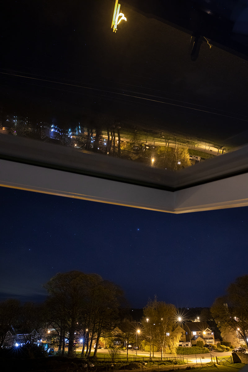 Night reflections into the attic window