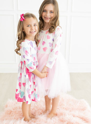 sisters in light hearted twirl and tutu dress