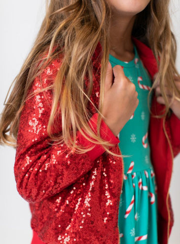 red sequin jacket over christmas candy twirl dress