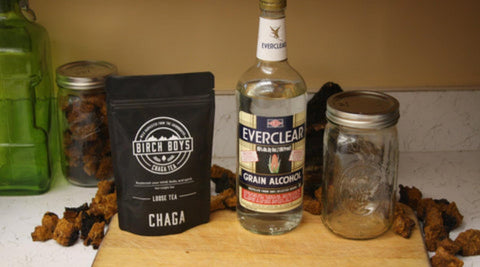 Birch Boys Loose Chaga Tea, Everclear Alcohol and a mason jar on a cutting board