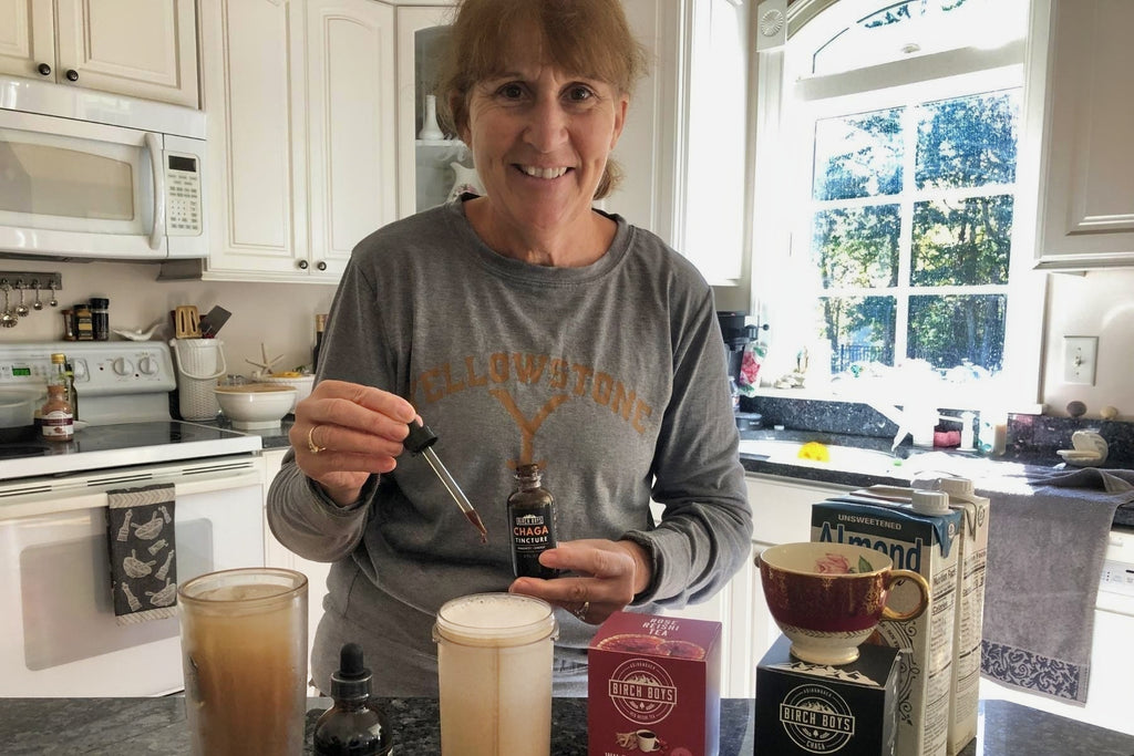 Smiling woman adds Chaga Tincture to beverage
