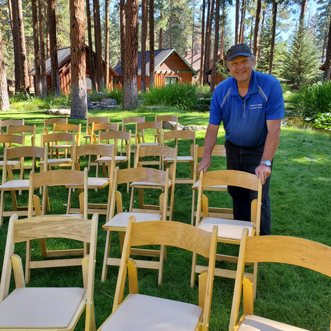 Wood wedding chairs set up for ceremony 