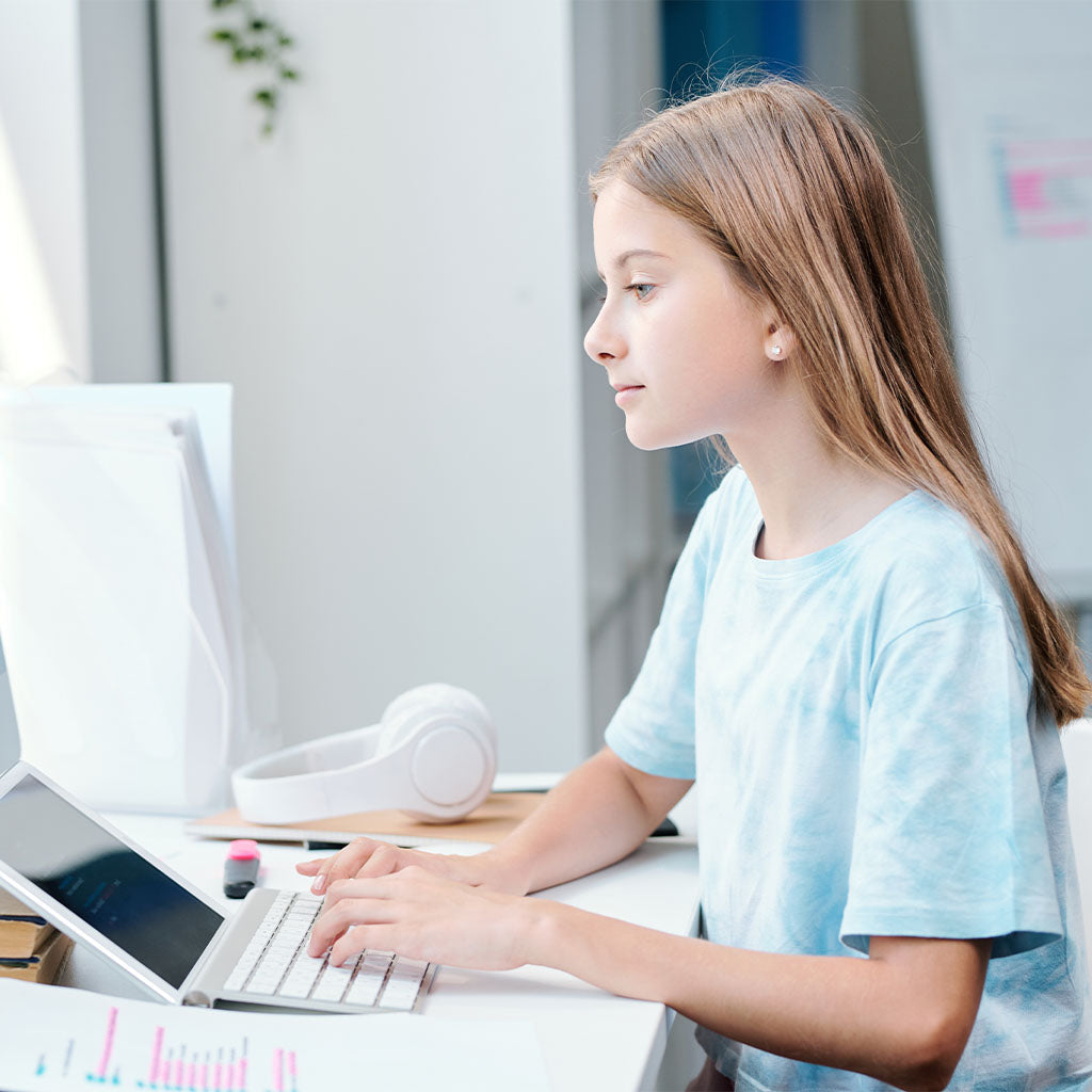 the child is studying at the computer