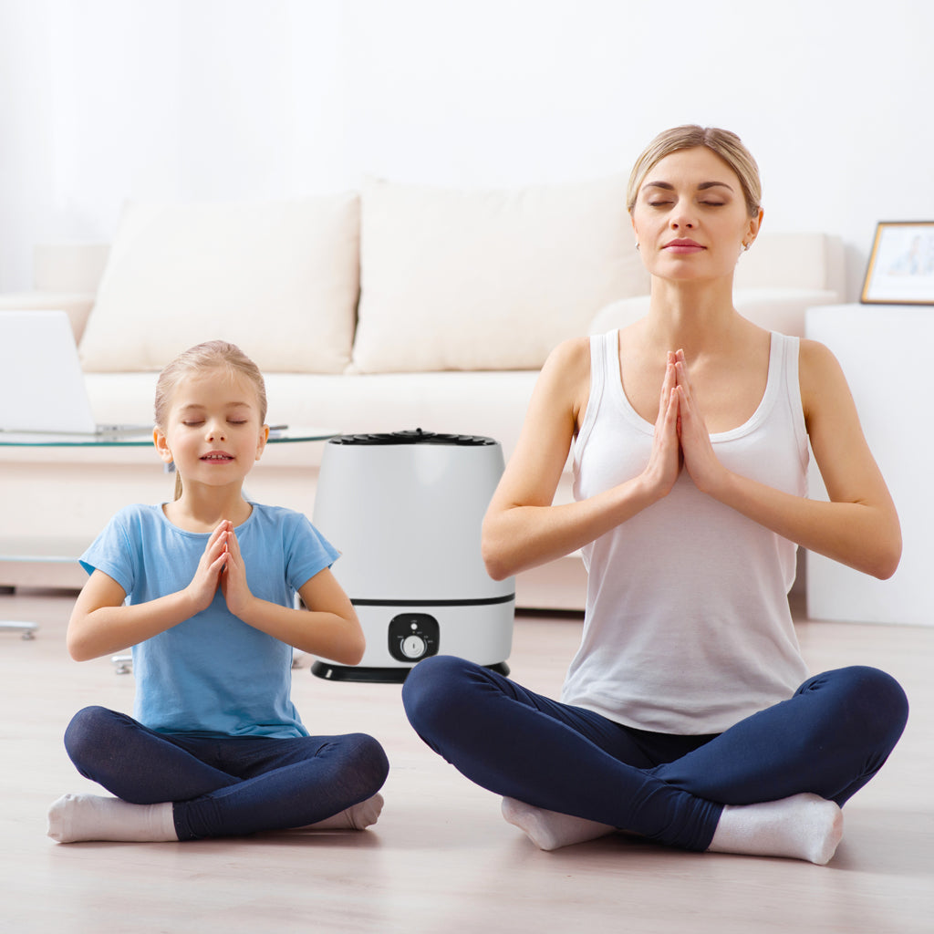 mother and daughter meditate in lotus position