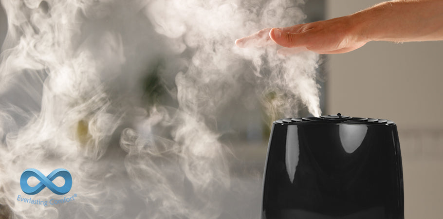 hand covers steam from humidifier