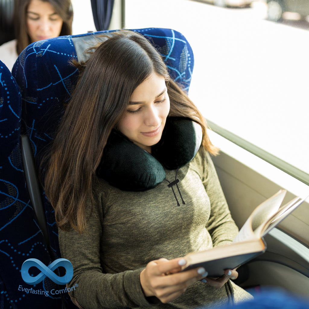girl reading a book on the bus