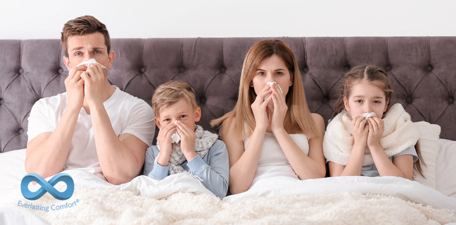 family blowing their nose in bed
