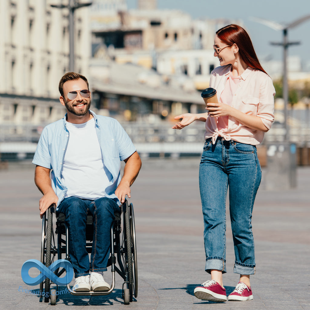 a young man in a wheelchair and a girl walking