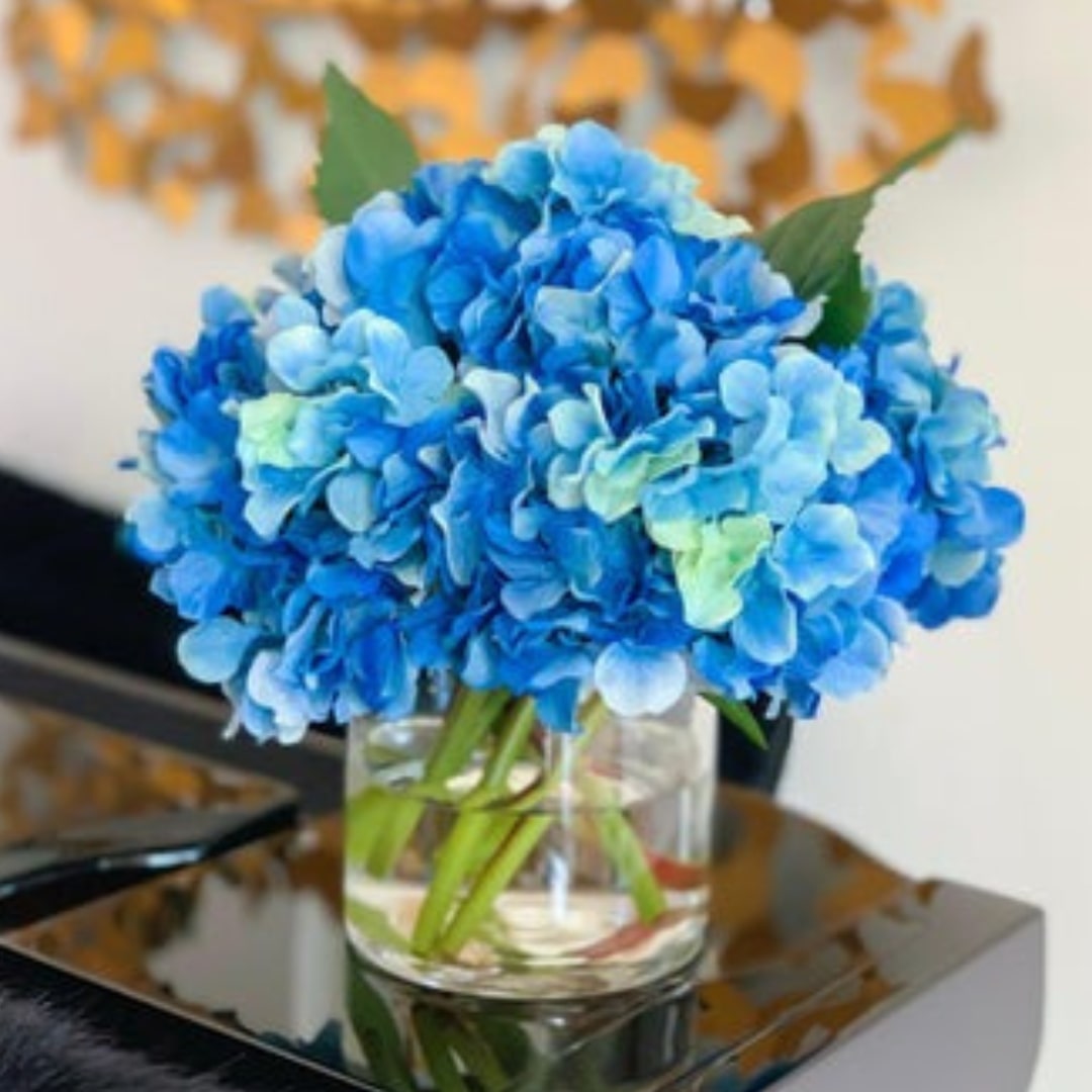 Blue hydrangeas in glass vase