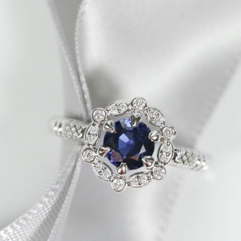 sapphire engagement ring with intricate diamond halo 