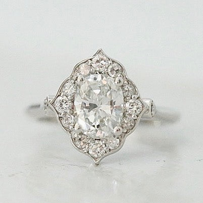 oval diamond engagement ring with intricate diamond halo