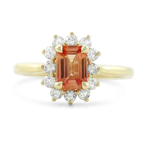 emerald cut red sapphire engagement ring with a white diamond halo and yellow gold band