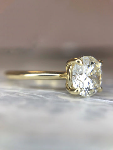 Custom diamond solitaire engagement ring with a gold band