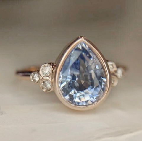 Light blue sapphire engagement ring with heirloom diamonds