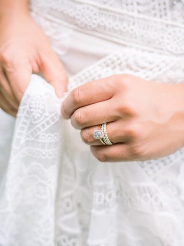 gray diamond engagement ring with white gold diamonds and a yellow gold band paired with two white diamond eternity wedding bands