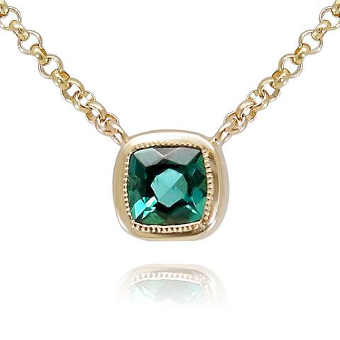 bezel set green tourmaline gemstone necklace with a yellow gold chain