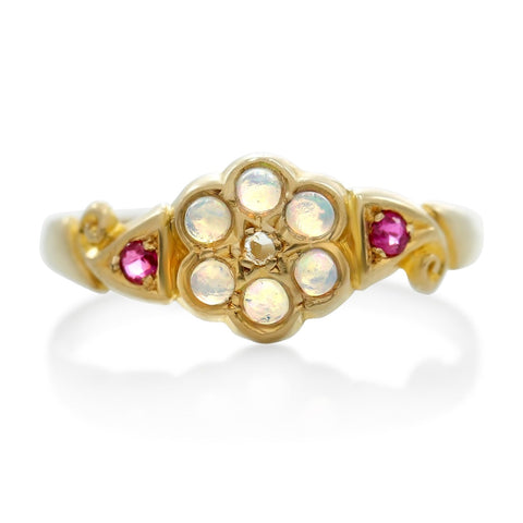 opals and rubies with a rose cut diamond in the shape of a flower victorian estate ring with a yellow gold band