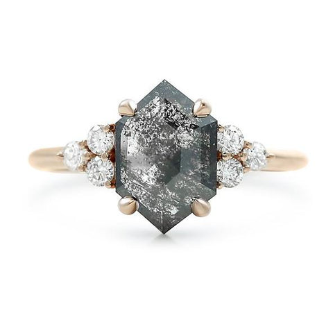 hexagon shaped salt and pepper diamond ring with white diamond side stones and a rose gold band 