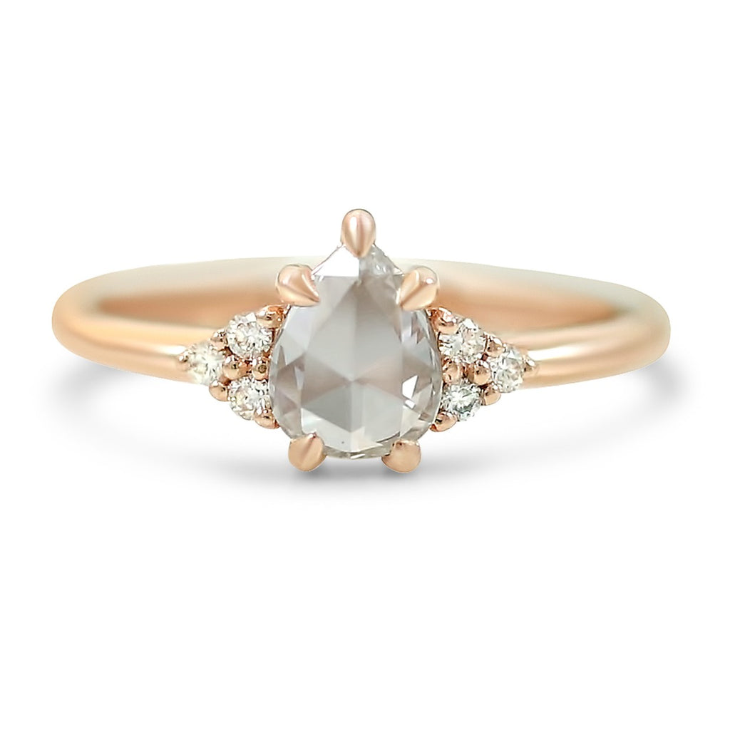 14k rose gold pear shaped rose cut diamond engagement ring with round diamond clusters prong set on either side
