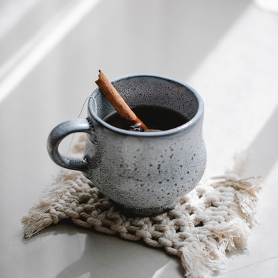 Blue mug with chai tea and cinnamon stick