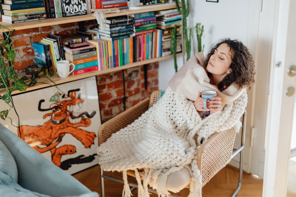 Woman Wrapped In A Blanket Drinking Tea