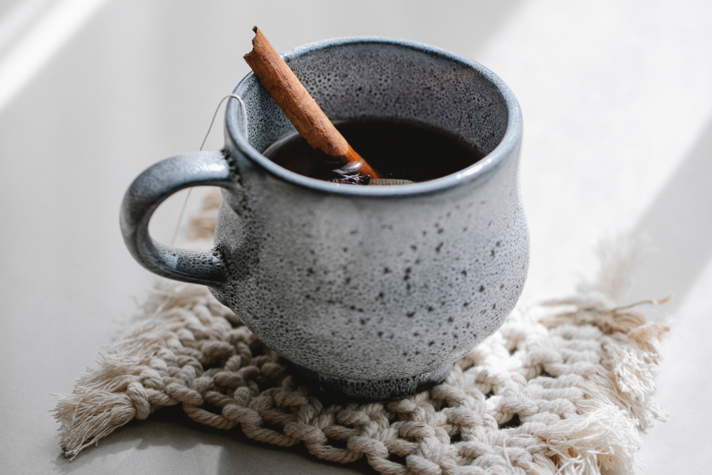 Blue mug with chai tea and cinnamon stick