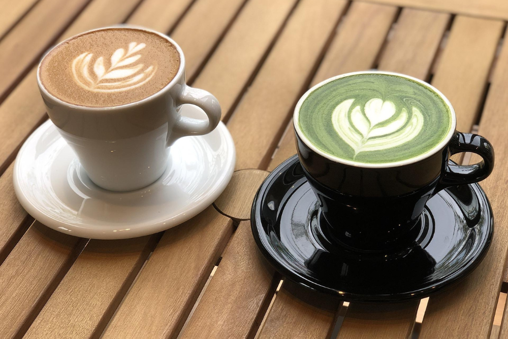 Matcha latte and coffee latte on a wood table