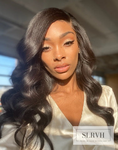 Woman wearing a glueless Lace Frontal Wig Wavy HAir by SL Raw Virgin Hair