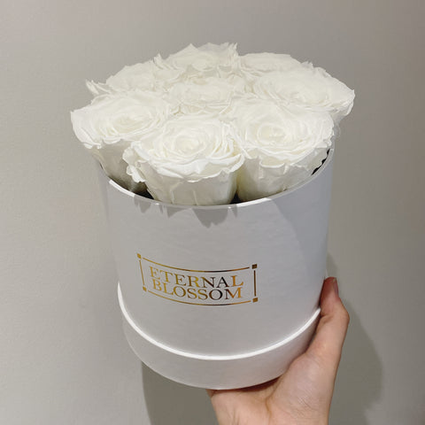 snow white roses in a round box