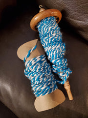 Finished plied yarn with drop spindle