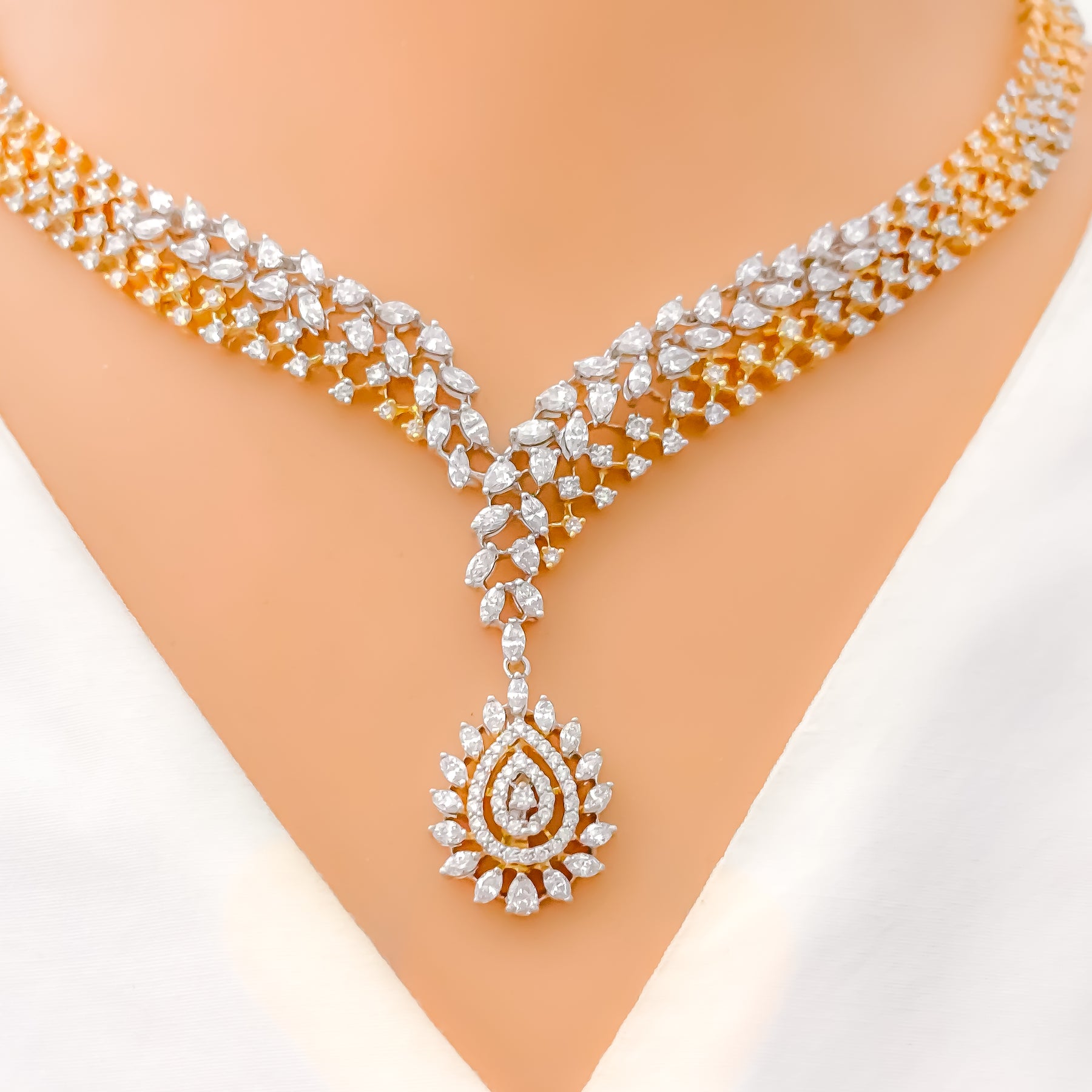 gold necklace with white stone designs