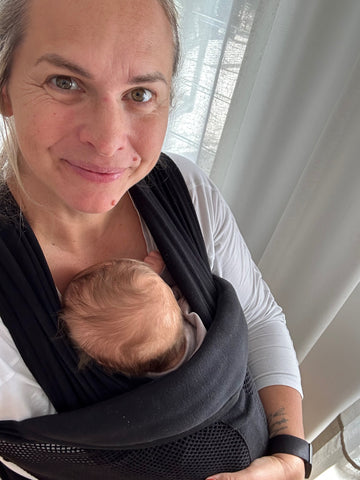 Mother and former Olympian Libby Trickett wearing her baby in a carrier