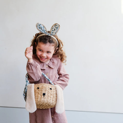 Little girl holding easter bunny straw basket