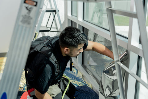 window tinting installer tinting commercial window with commercial window film