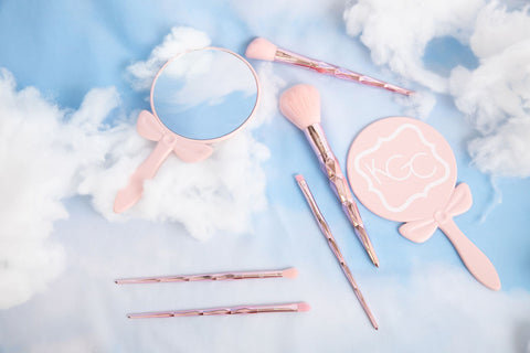 Indy makeup brushes and Castleton Mirror against a clouds backdrop with blue skies.