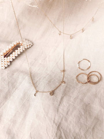 Dainty gold chain necklace spelling Love
