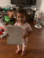 toddler holding drawing pad